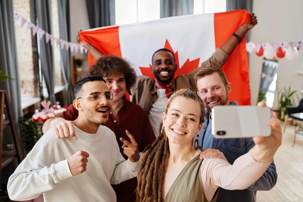 pexels-photo-7219363-7219363 A diverse group of friends celebrating Canada Day with a joyful selfie indoors.